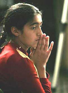 an Iraqi high school student listens to a video conference